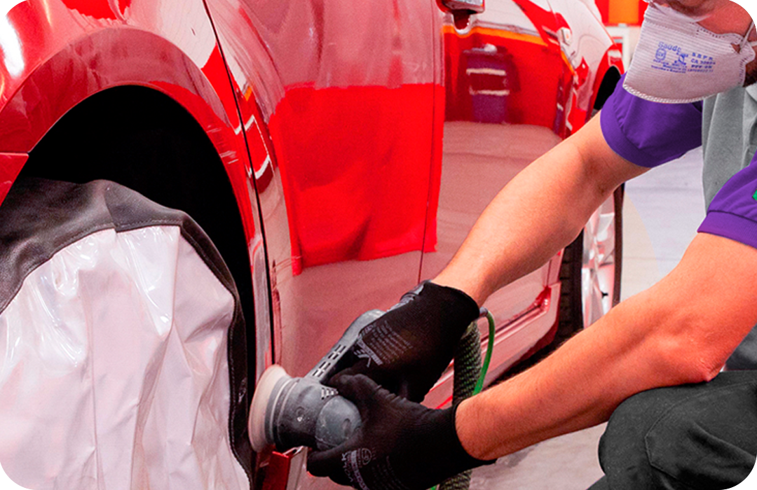 Specialist repairing dent in car
