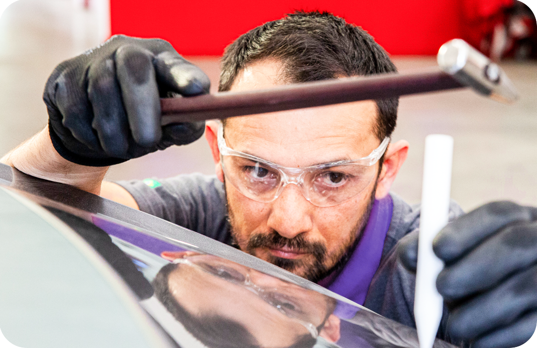 Specialist repairing dent in car